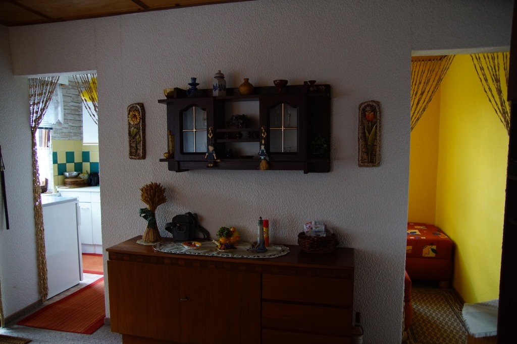 Kurze Wohnzimmerwand - links die Tür zur Küche, rechts der Eingang zum Schlafzimmer